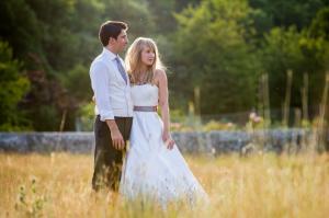 bride and groom at sunset in field behind birling manor in east sussex 